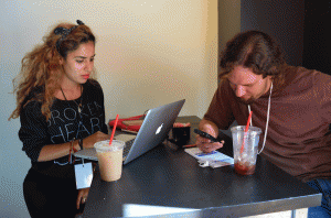 A coffee shop serves as a temporary newsroom for Pup-Up Newsroom reporters Amal Aziz and Ron Rokhy, who curate other students' content. Photo courtesy of Melissa Wall.
