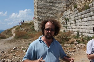 Art history professor Owen Doonan at the site of the North Tower — one of the four sites in the Stones Sounds exhibition — in ancient Sinop. Behind him, the walls are 2,200-years-old. Photo by Gregory Thoma.