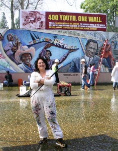 Judy Baca in front of the Great Wall of Los Angeles.