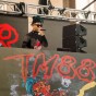 Hip hop DJ TM88 performing on stage in a CSUN shirt.