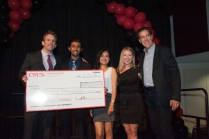 Ryan Holbrook (far left), head of the entrepreneurship program in the Nazarian College, and business leader and CSUN alumnus Jeff Marine (far right) present members of the Vibe Probiotics team — from left, Abed Rahman, Erika Elizalde and Katie Teevin — with a check for $25,000 at the 2016 Bull Ring Finals.