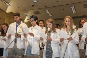 CSUN Doctorate of Physical Therapy Program members stand and read the doctor's oath at their White Coat ceremony in August 2016. Photo by Luis Garcia. 