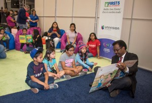 CSUN Vice President for Student Affairs and Dean of Students William Watkins reads to a group of young people at Feria de Education 2016. Photo by Lee Choo.