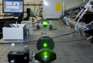 The cavity ringdown spectrometer was custom built by atmospheric chemistry professor Daniel Curtis. Comprised of a green laser which bounces between two mirrors inside a metal canister, it measures the refractive index of aerosol particles. Photo by Luis Garcia. 