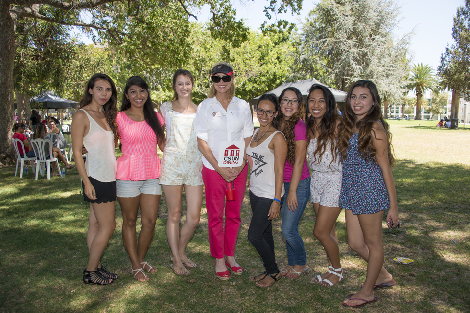 CSUN President Dianne F. Harrison smiles for pictures with a group of young students at last year's President’s Picnic. Photo by Lee Choo