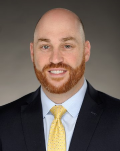 Portrait of alumnus Jeffrey Felix, wearing a suit.