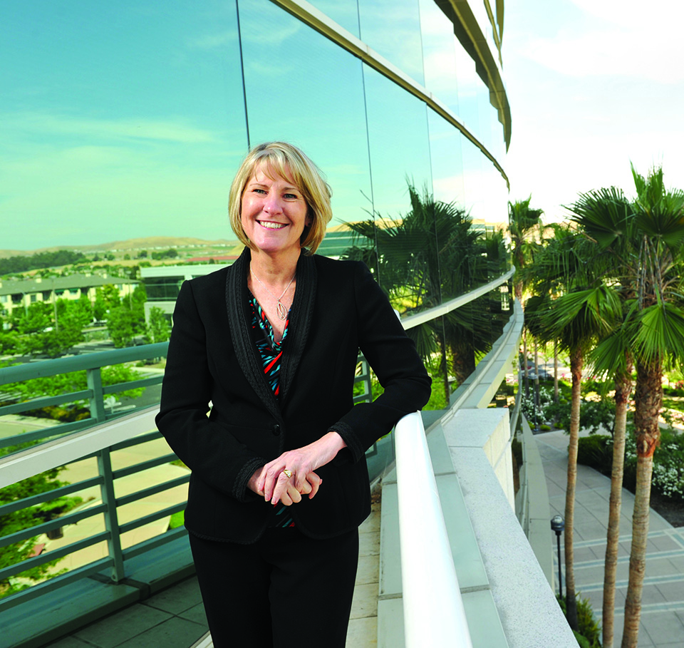 Alumna Priscilla Moyer stands on a patio overlooking Franklin Templeton's tech center in the East Bay Area.