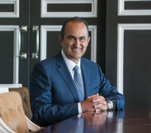 Alumnus David Nazarian, CEO of Nimes Capital, sits at table in his offices.