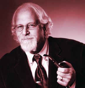 Portrait of alumnus Craig Leener, holding a tobacco pipe.