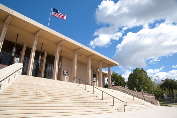 Color image of the Oviatte Library with clouds in the background