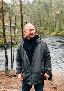 CSUN student and music education entrepreneur Richard Frank stands by a stream in Helsinki.