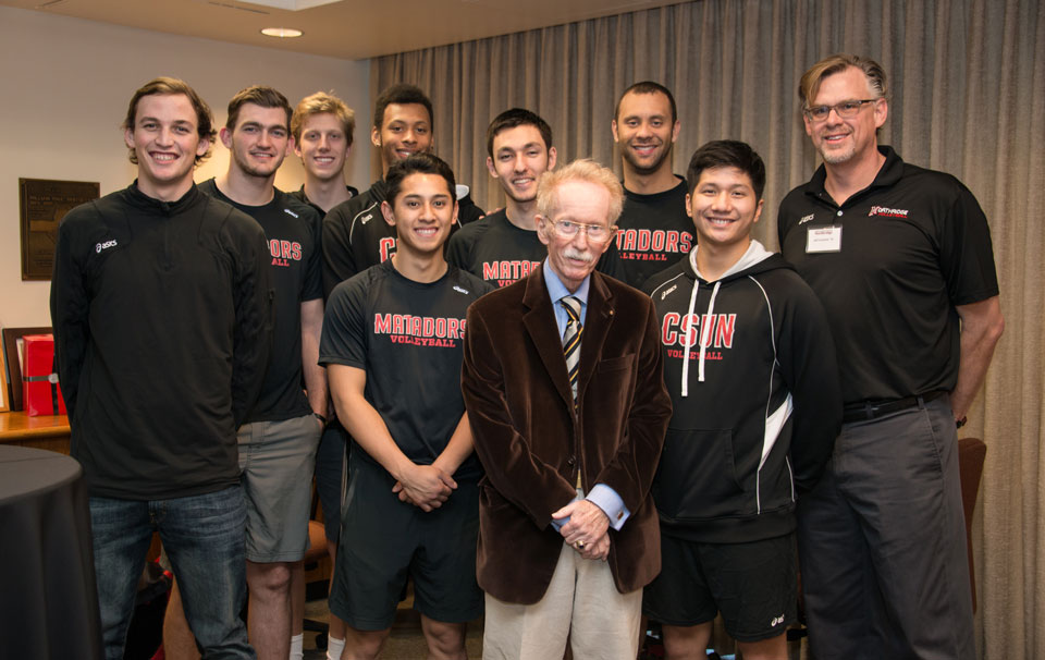 James "Doc" Sefton stands with members of the CSUN men's volleyball team and head coach Jeff Campbell, on Feb. 12, 2015, in the Whitsett Room of Sierra Hall.