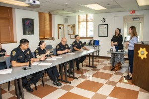 Criminology and justice studies assistant professor Katherine Lorenz (far right) and criminology and justice studies chair Vickie Jensen (second from right) speak to a group of CSUN police officers about the "Start by Believing" campaign. Photo by Lee Choo.