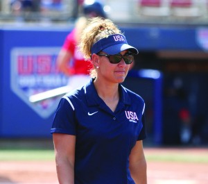 CSUN Women's Softball head coach Tairia Flowers stands at a softball diamond, wearing the coaching uniform of the USA Softball Women's National Team.