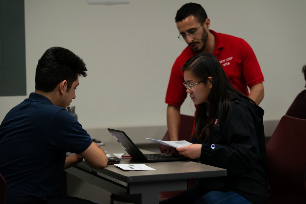 CSUN VITA clinicians assisting student with tax-preparation services. 