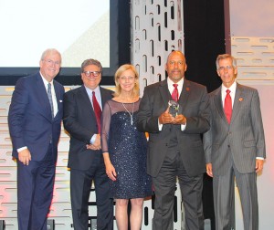 Five people, including CSUN President Dianne F. Harrison, center, stand next to CSU Dominguez Hills President Thomas Parham as he accepts his university’s 2019 Eddy Awards. Far left: Bill Allen Hon.D. ’14, CEO of the LAEDC.