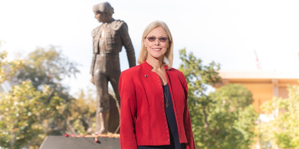 CSUN President Dianne F. Harrison stands in front of CSUN's Matador statue.