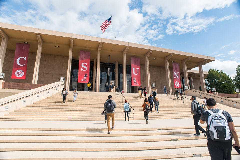 Color image of students walking up the steps of the Oviatt Library.