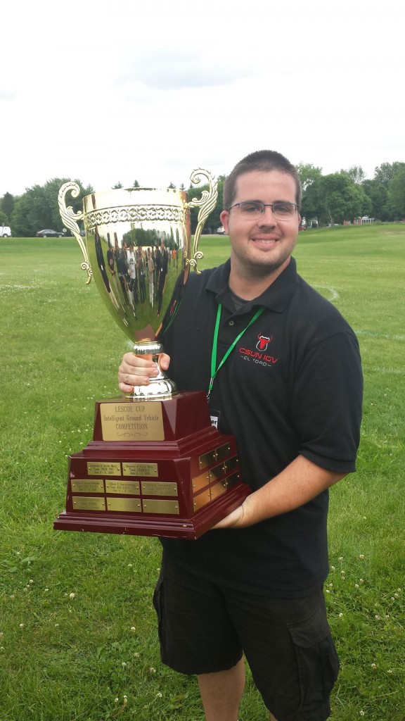 Mechanical engineering senior, Erik Wagner, holds the first place trophy at the 2015 International Ground Vehicle Competition at Oakland University in Michigan. Photo courtesy of C.T. Lin 
