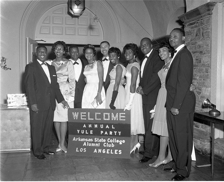 Ten members of the Arkansas State College Alumni Club pose in formal wear in Los Angeles in 1962.