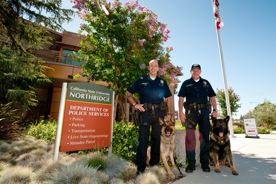 Two police offices with their dogs.