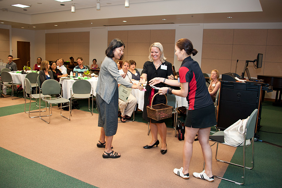 Faculty members Yoko Mimura, Whitney Scott and Jongeun Kim have some fun in front of a group during a faculty development session.