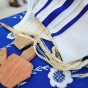 Ancient pottery pieces from Israel rest on a Jewish prayer shawl.