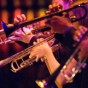 Close up of CSUN Jazz “A” band musicians playing brass instruments.
