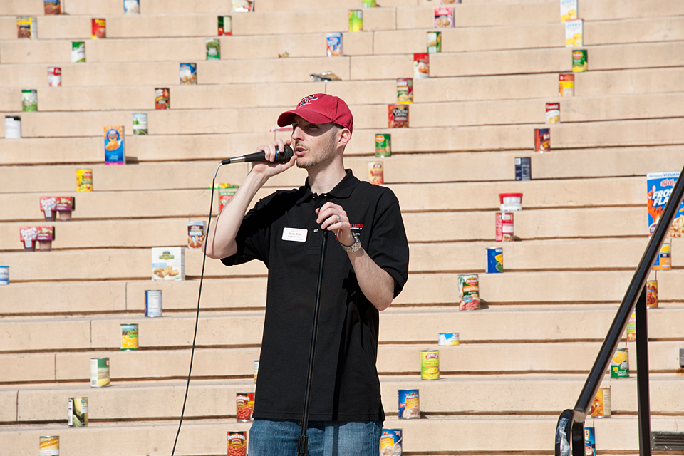 Justin Weiss, coordinator of Unified We Serve, offers his remarks during the culmination event on the steps of the Oviatt Library.