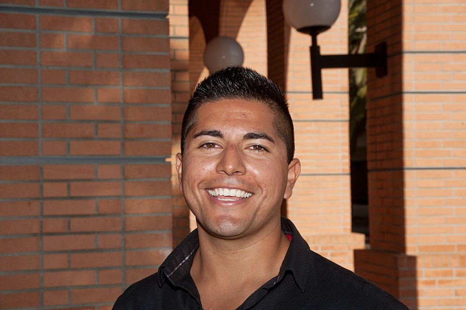 Alan Campos standing in front of the College of Business and Economics on the CSUN campus.