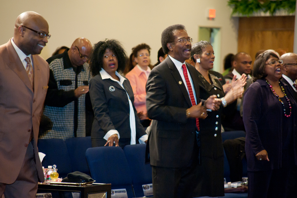 California State University, Northridge Vice President William Watkins singing along with the congregation at Living Praise Christian Center Church.