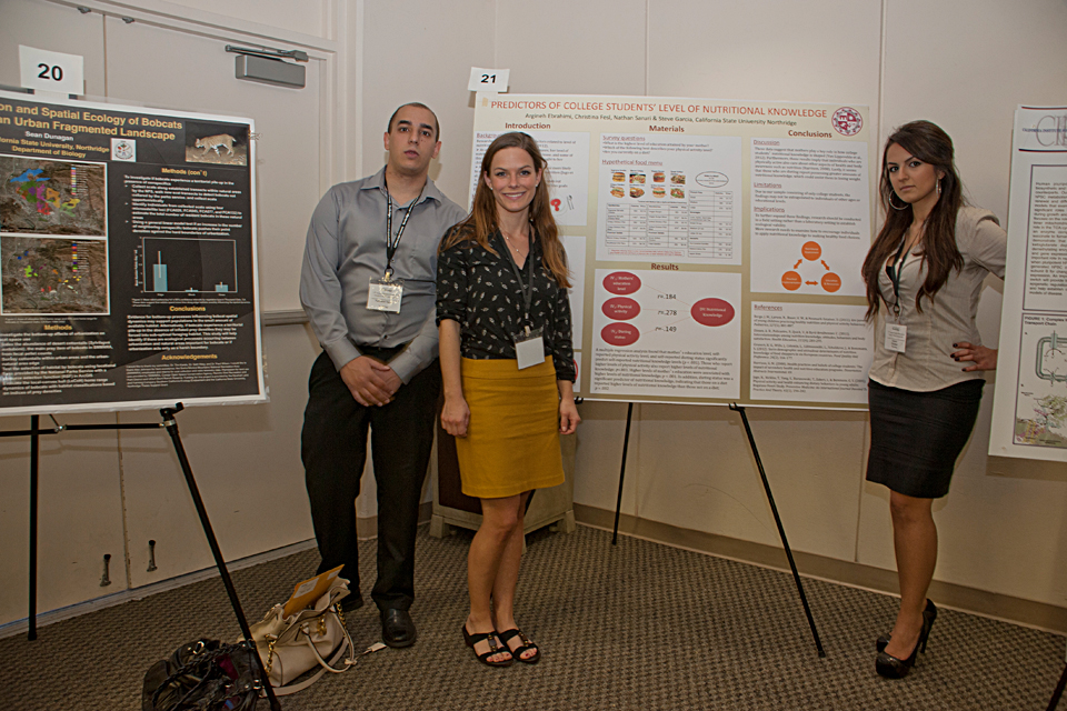 Psychology majors Nathaniel Saruri, Christina Fesl and Argineh Ebrahimi standing in front of their project poster.