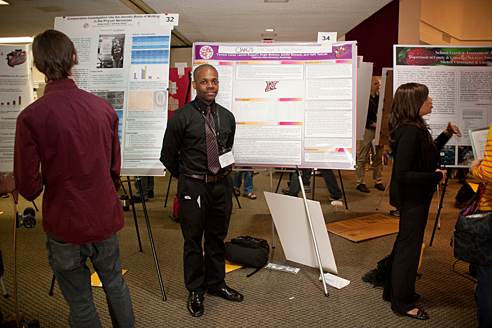 Tawaun Lucas of the psychology department standing in front of his project’s poster.