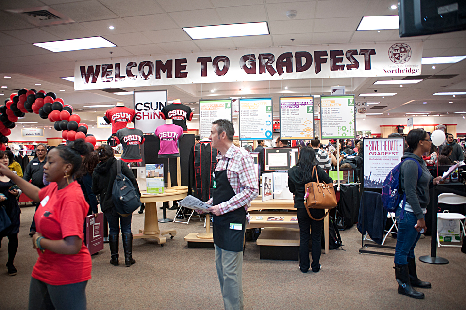 Employees and students standing in the Matador Bookstore Complex during GradFest 2013.