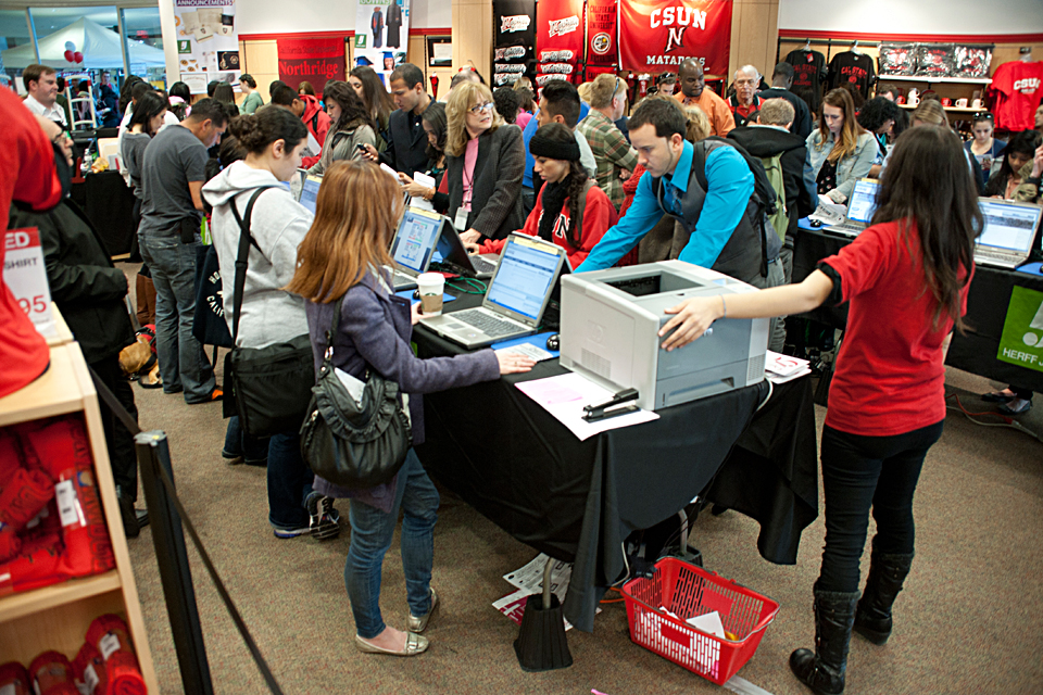 Students standing in front of laptops.
