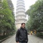 Dale Chang in front of a traditional Chinese tower.