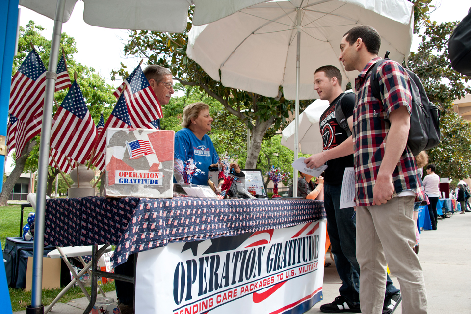Students visit Operation Gratitude booth.