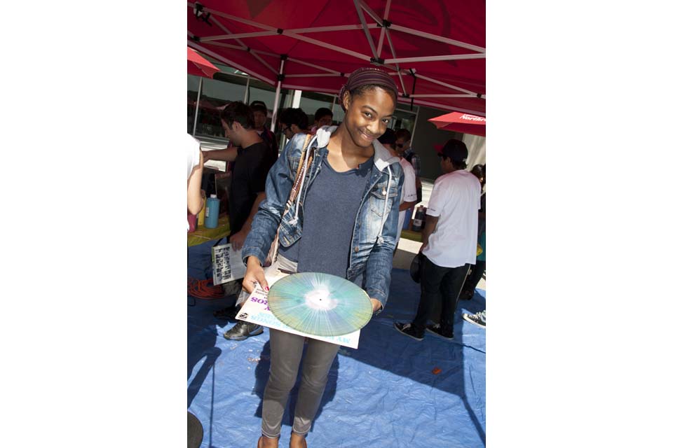 Psychology major Jade Howell holding a painted record.