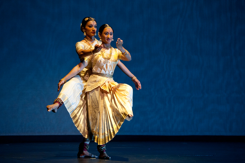 Two women performing an Indian-style dance.