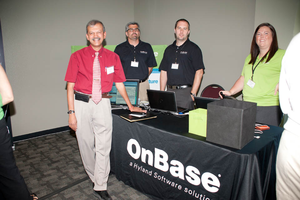 A college dean poses with three OnBase representatives
