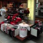 T-shirts and other CSUN-branded items on display in a kiosk.