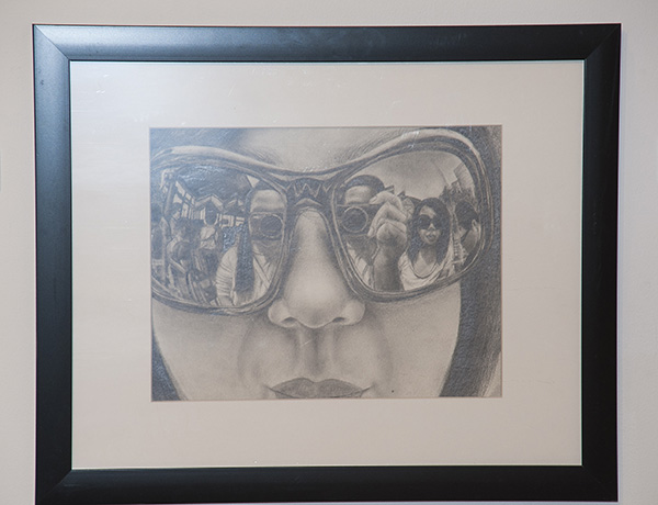 Granada Hills Charter High School's Faith Ignacio illustrates a woman with sunglasses with pencil in 