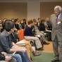 The Rev. James Lawson lectures to a hall of students from multiple courses.
