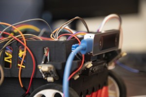 Close-up of a robot with multiple colorful cables. 