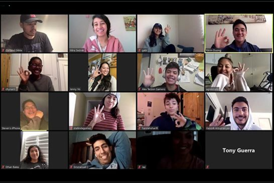 A Zoom call gallery view of students smiling and holding up 3 fingers.