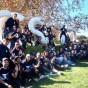 Trainers from 3WINS Fitness pose in front of a CSUN sculpture