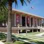 Library with red banners and palm trees in foreground