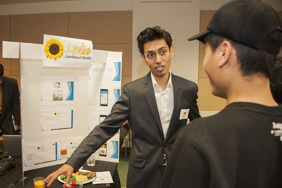 Male student presents Helia Nutrition, which won third place in the research track of AI-Jam.