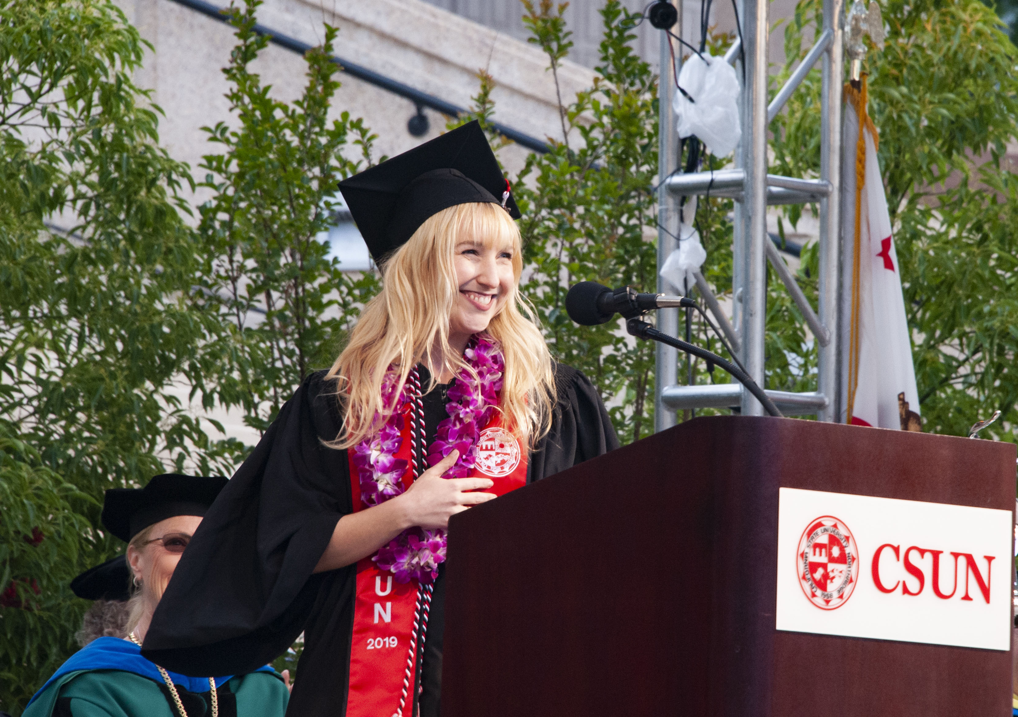 A member of the Class of 2019 speaks at a podium at commencement.