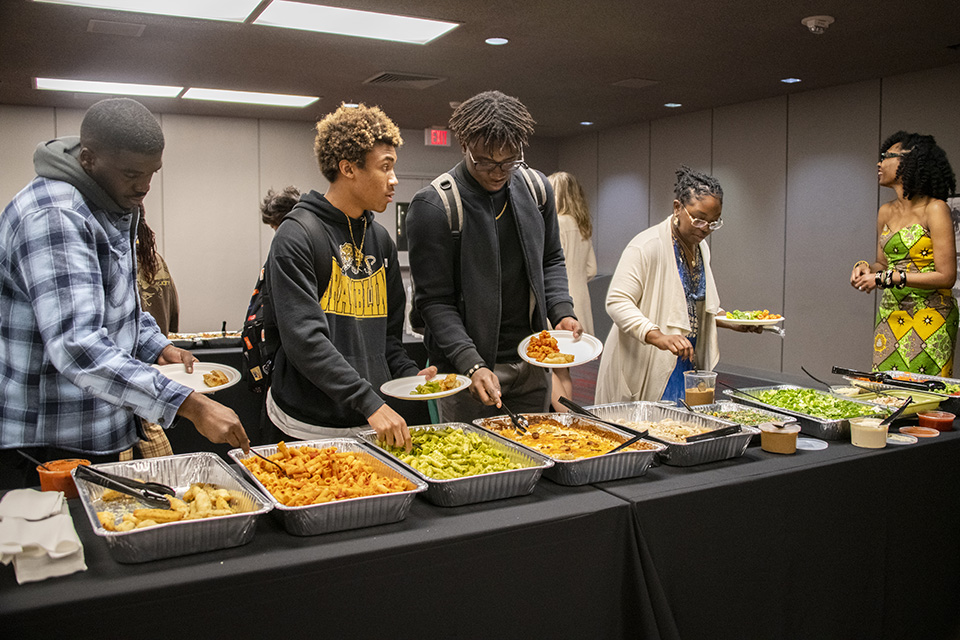 Students serve themselves at a buffet